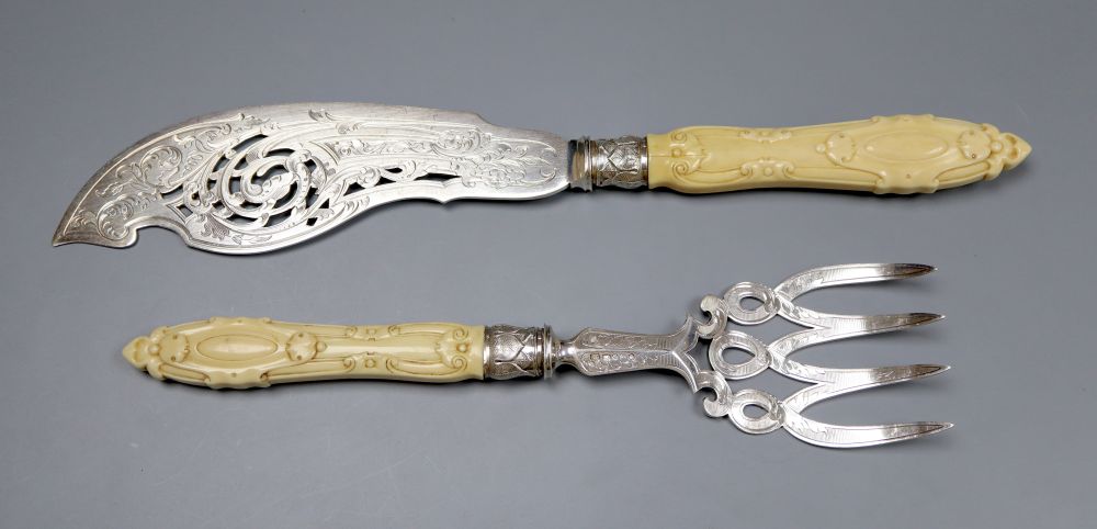 A pair of Victorian carved ivory handled silver fish servers, John Round, Sheffield, 1856, knife, 33.6cm, gross 9.5oz.